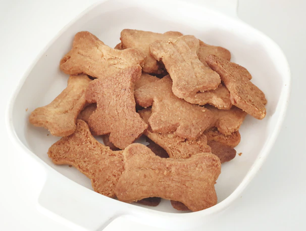 Artisanal dog cookies arranged in a rustic wooden tray