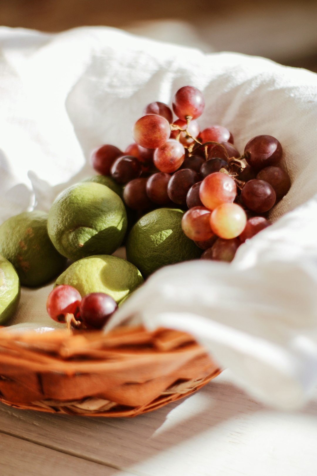 green and brown fruits on brown woven basket