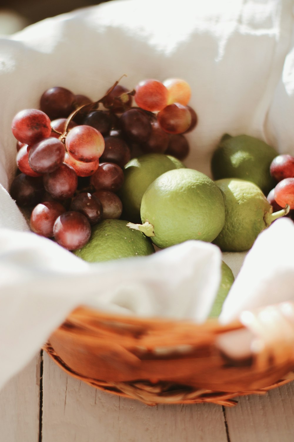 green and brown round fruits on white plastic bag