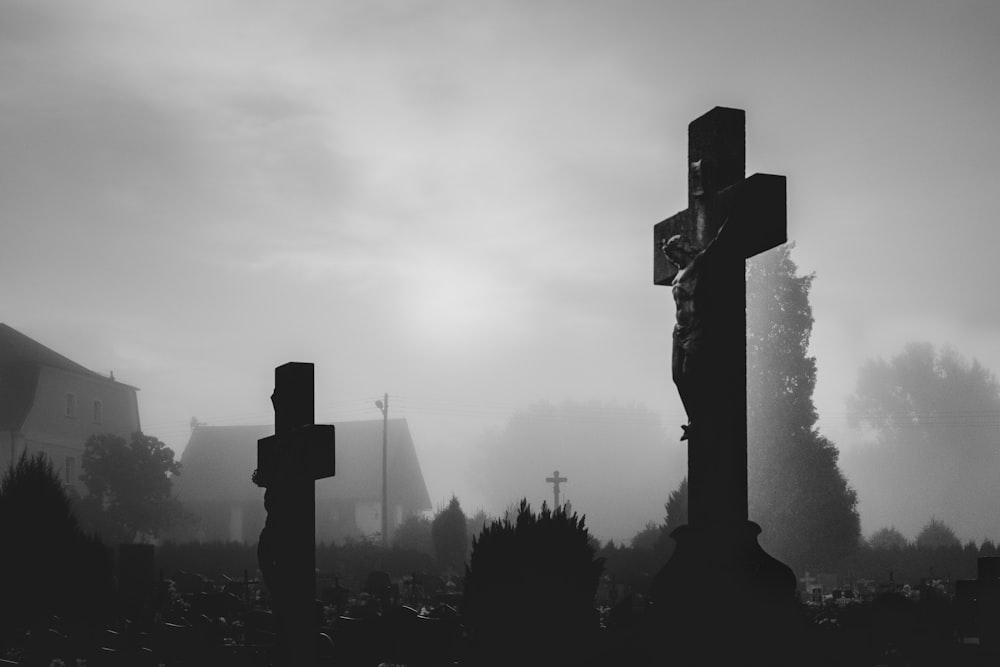 silhouette of cross under cloudy sky during daytime