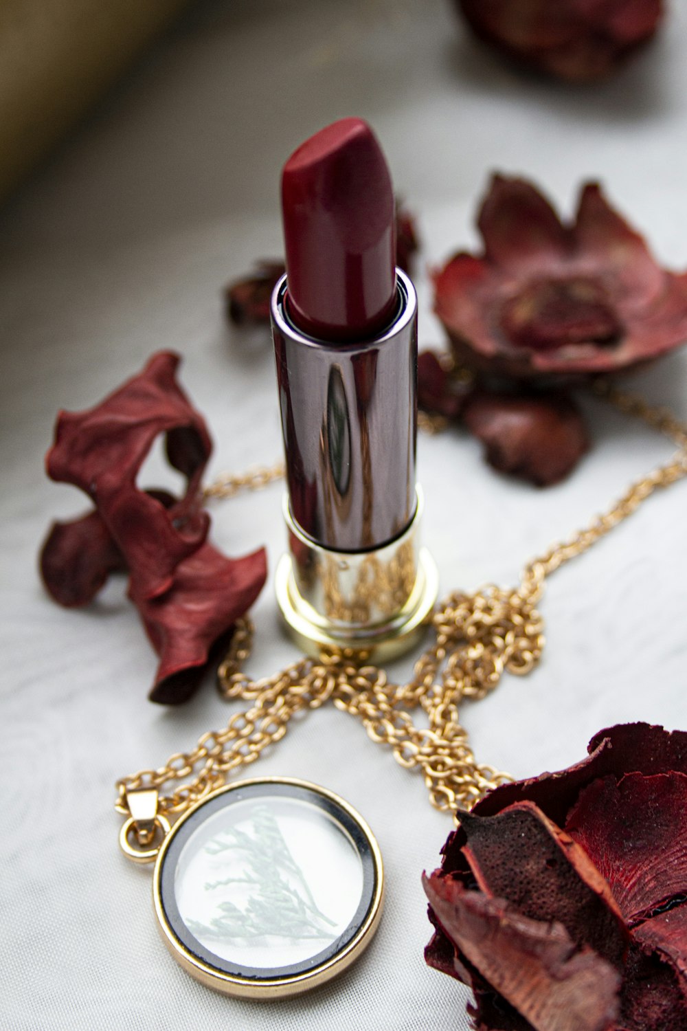 gold and red lipstick on red textile