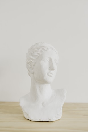 Close-up of a marble bust with a headset, symbolizing attentive customer support.