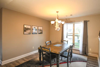 A bright dining room with a handcrafted wooden dining table and matching chairs.