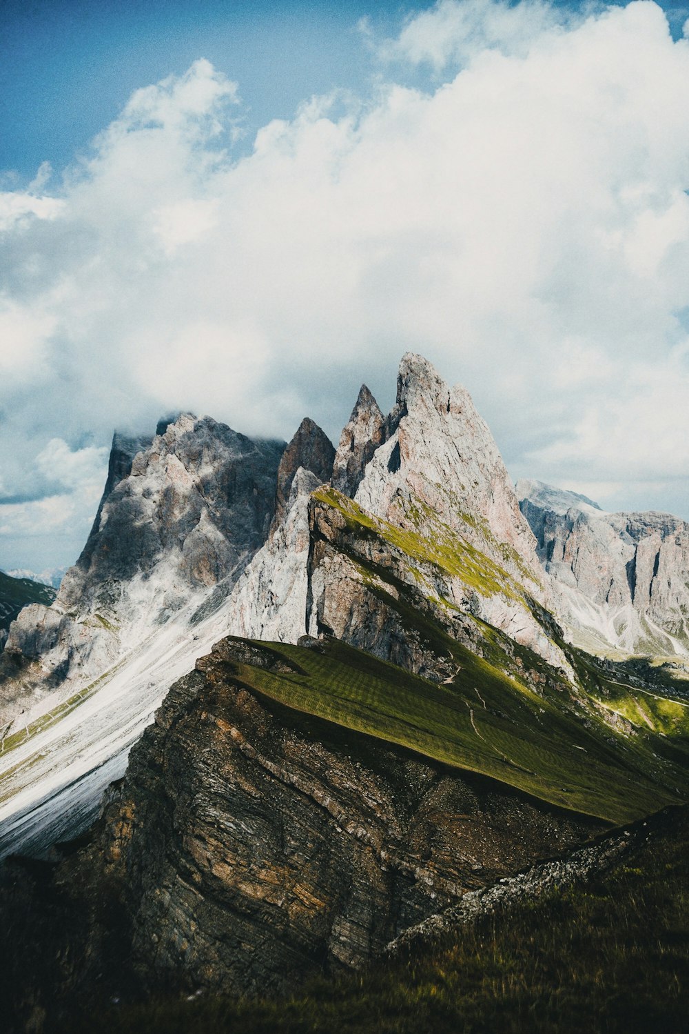 green and brown mountain under white clouds during daytime