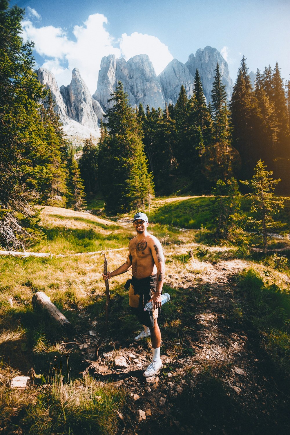 man in brown shorts walking on brown dirt road during daytime