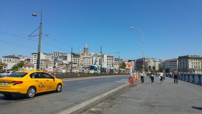 A scenic view of a tourist destination with a taxi in the foreground.