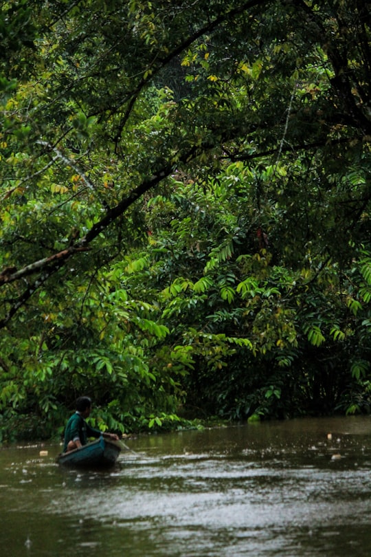 man in blue shirt riding on blue kayak on river during daytime in Nanga Pinoh Indonesia