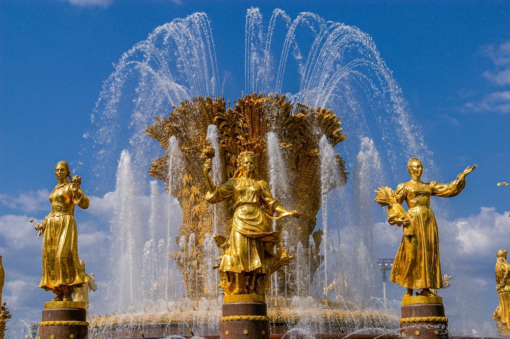 gold statue fountain during daytime