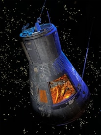 A spacecraft capsule is floating in space against a backdrop of distant stars. The capsule is sleek with visible panels and structure, showing an interior filled with complex machinery and tubing. The light inside the capsule creates a warm, orange glow contrasting with the cold, dark space outside.