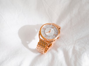 gold and white analog watch