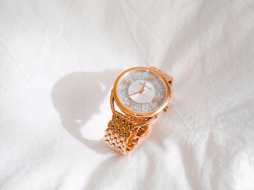 gold and white analog watch