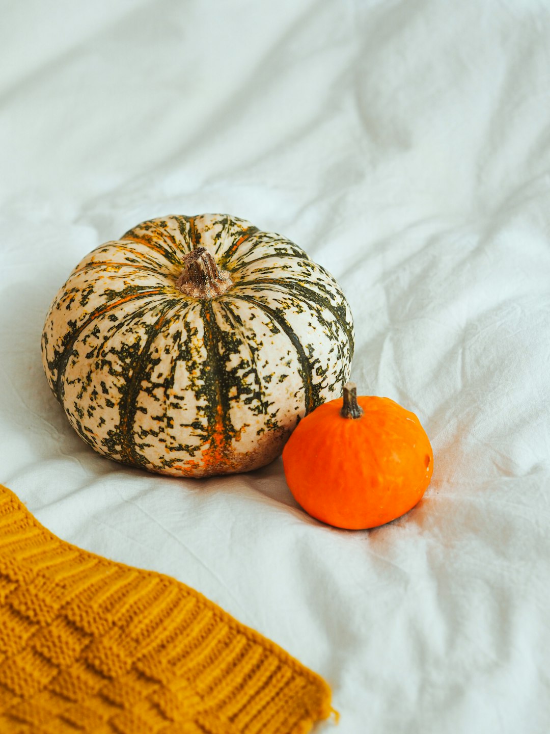 orange fruit beside yellow textile