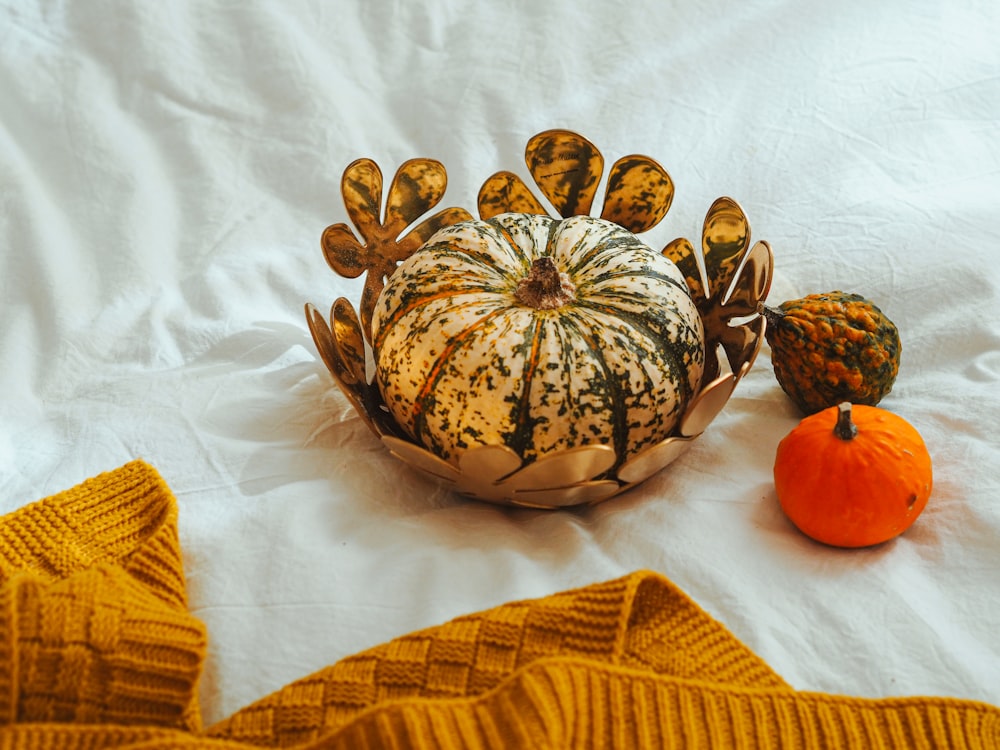 brown and black round fruit on white textile