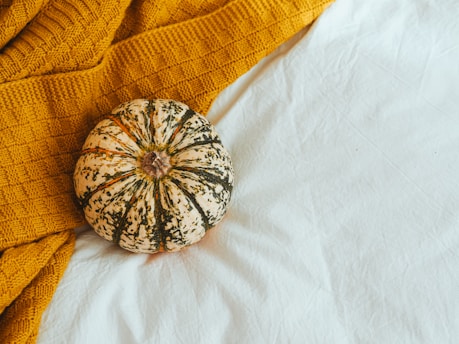 silver round ornament on white textile