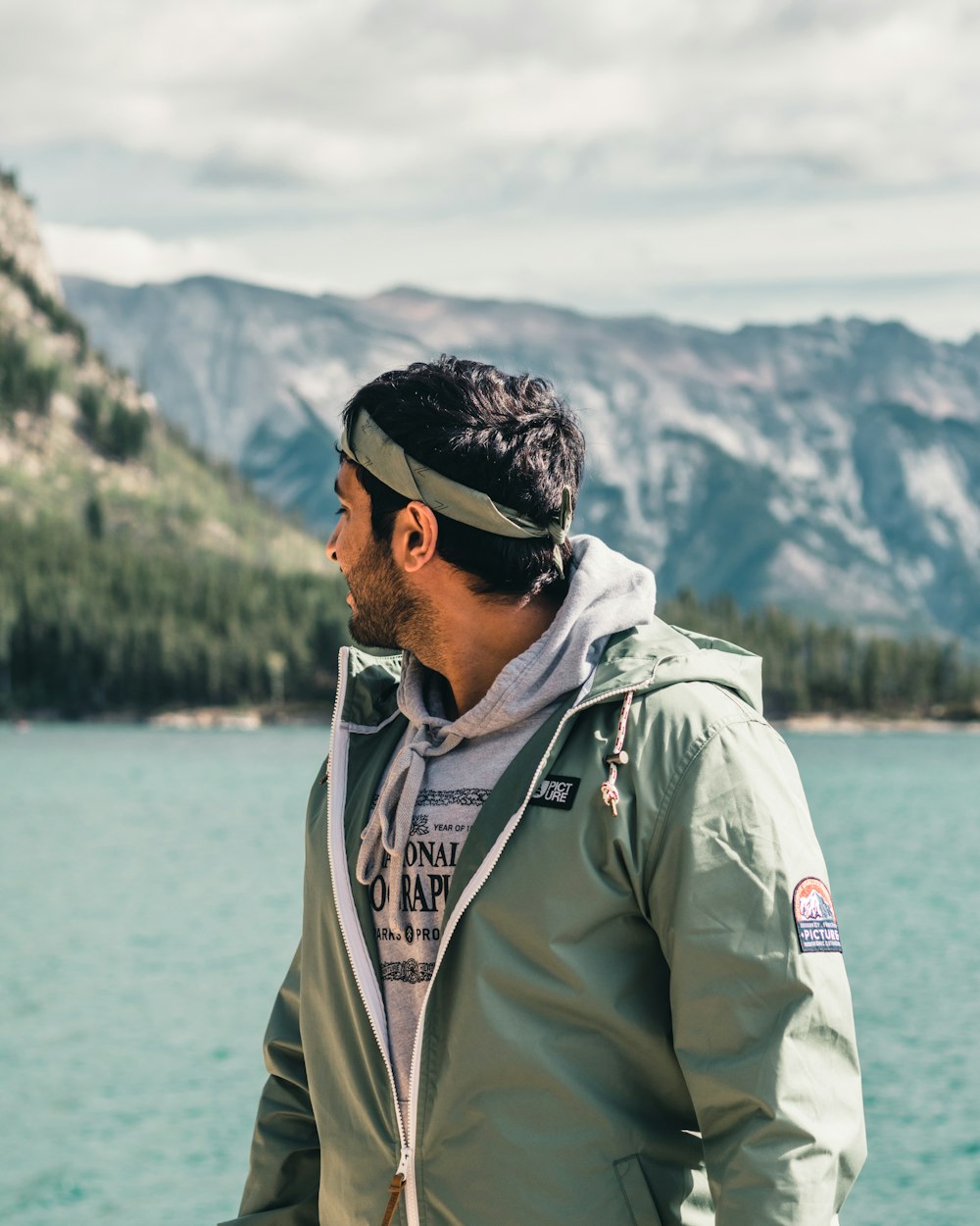 man in green jacket wearing black sunglasses