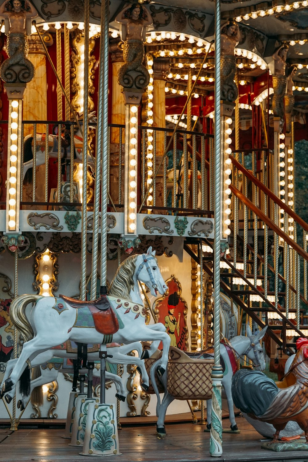 people riding on carousel during daytime