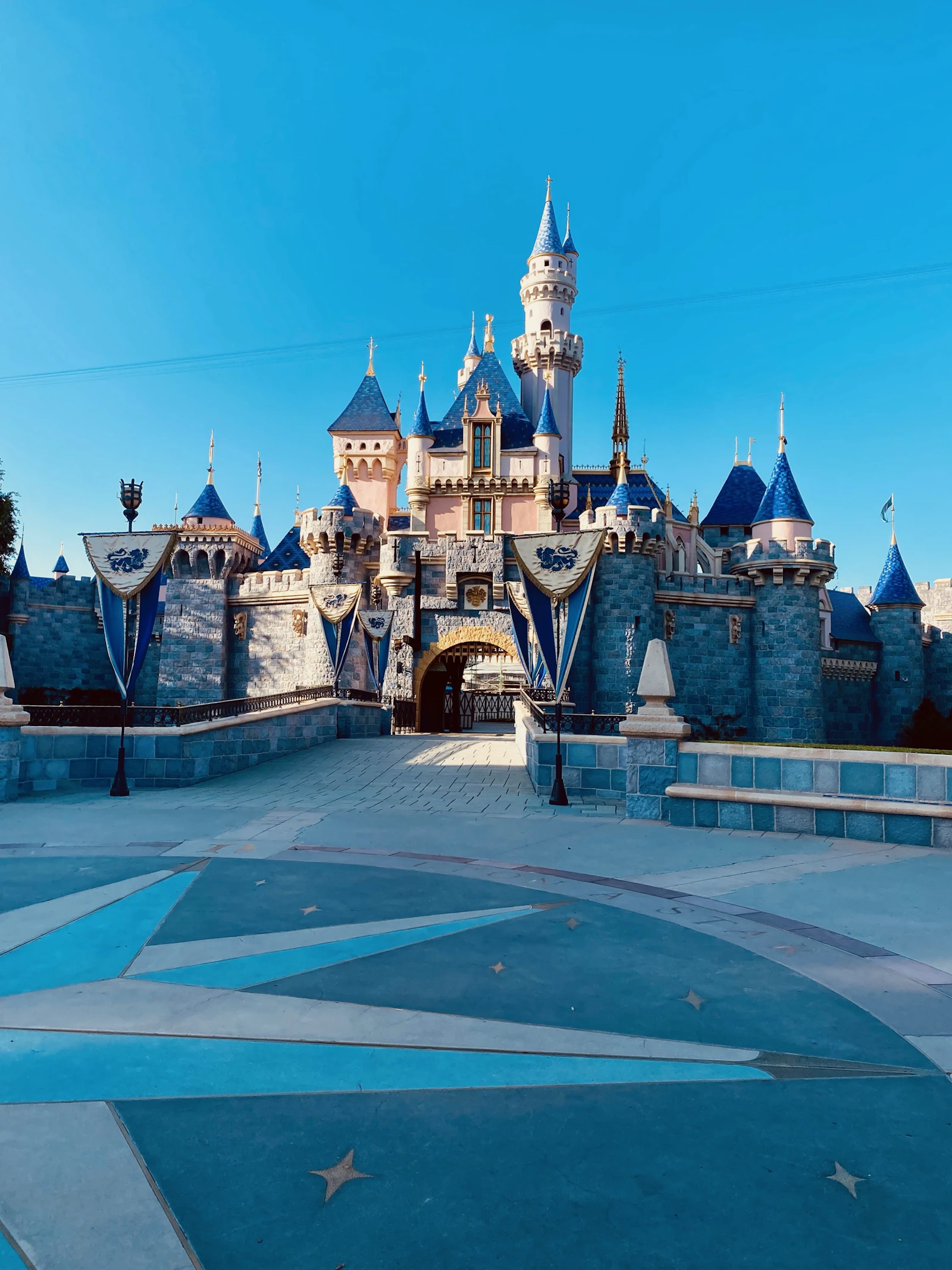 Sleeping Beauty Castle at Disneyland Park in Anaheim under a blue sky
