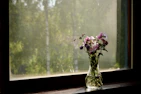 A peaceful corner with a handmade ceramic vase holding fresh wildflowers, glowing in natural light.