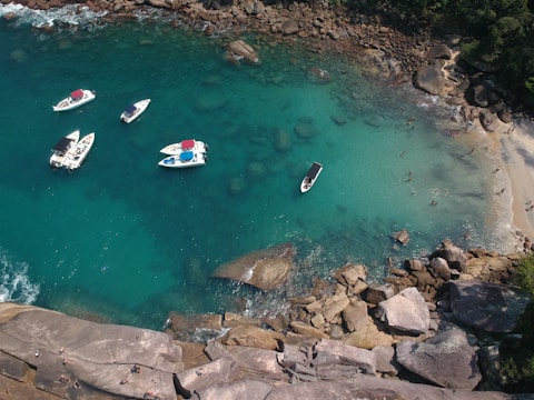 white and red boat on water during daytime