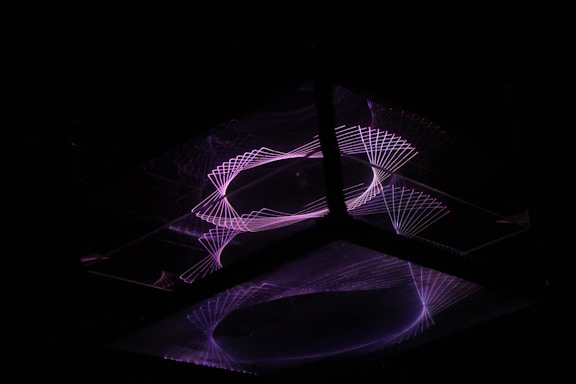 Close-up of geometric neural network patterns glowing softly against a dark slate background.