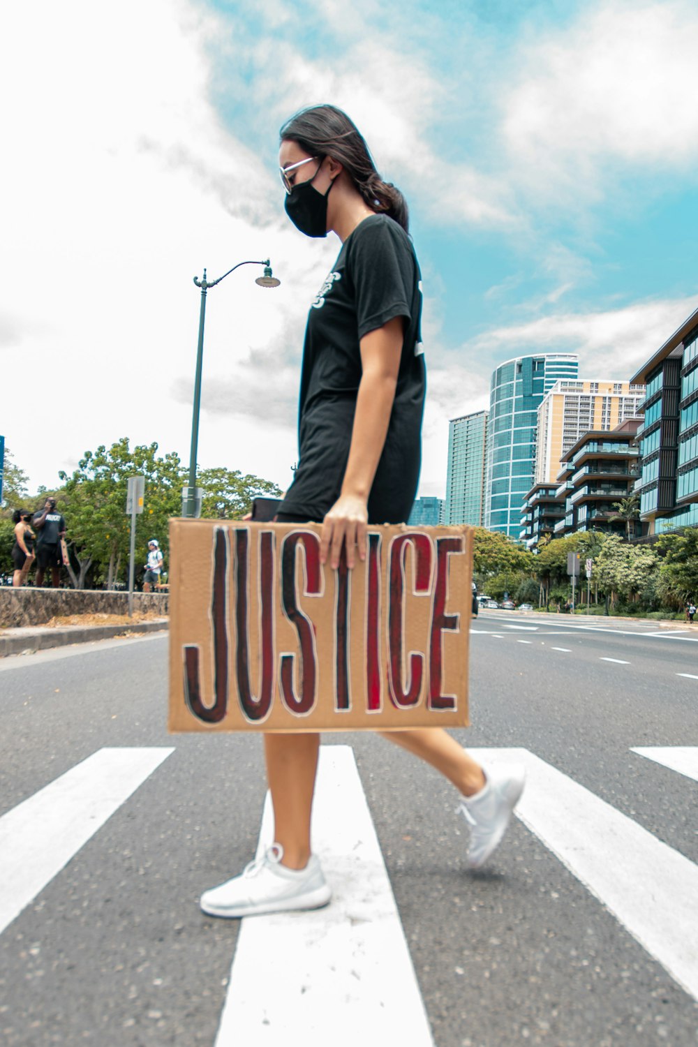 man in black t-shirt and black shorts holding brown and white love print board