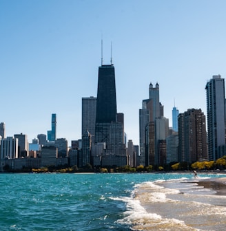 city skyline across body of water during daytime