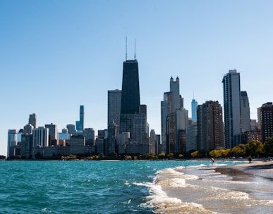 city skyline across body of water during daytime