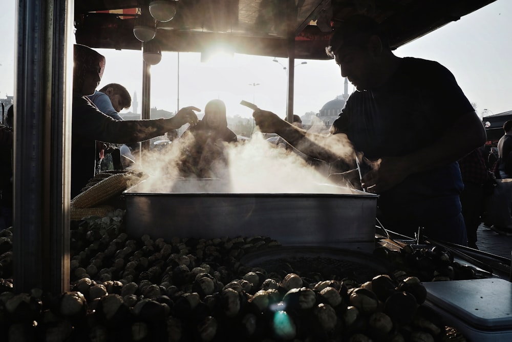 people in black shirt standing in front of table with food