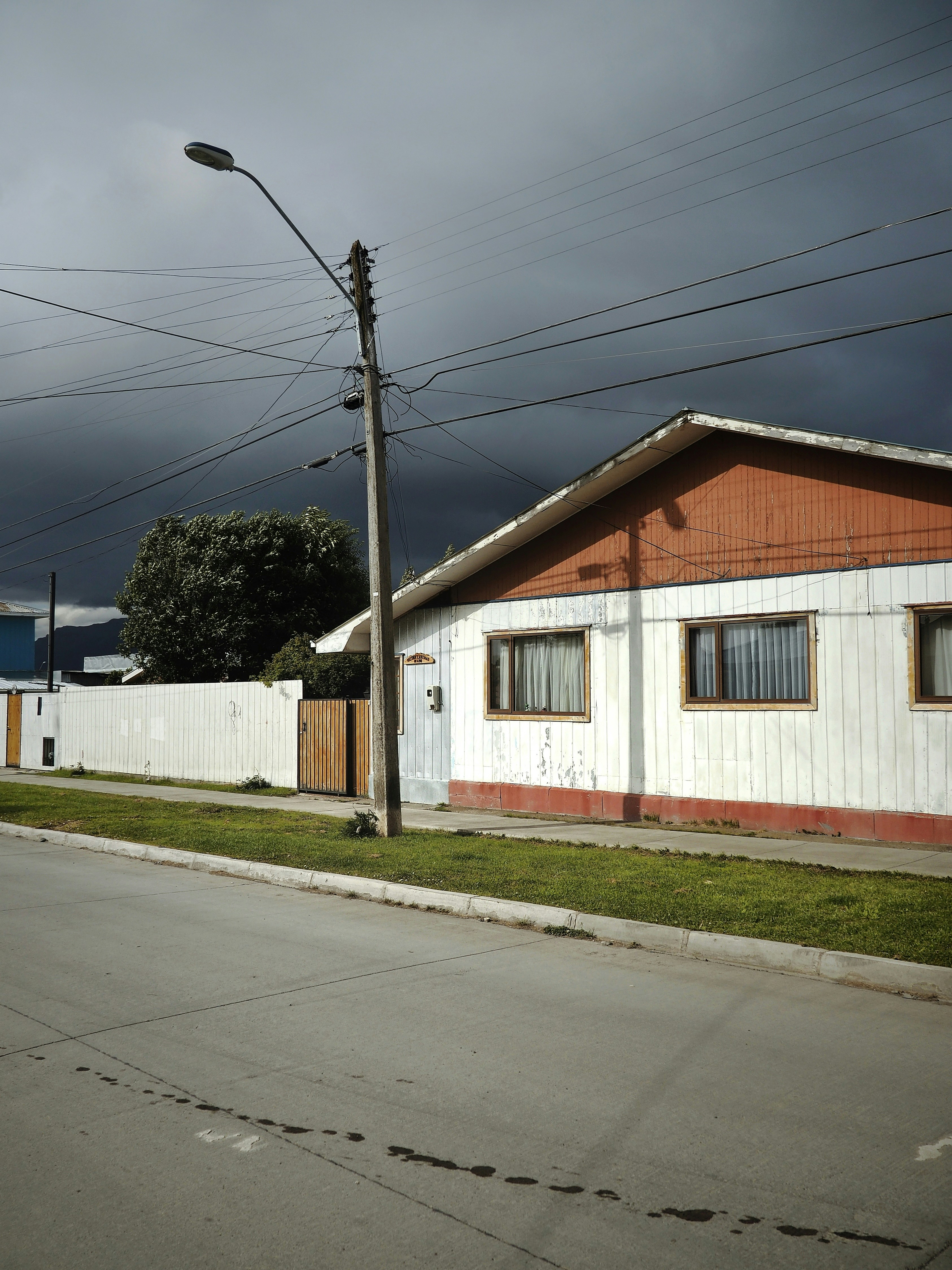 white and brown wooden house near gray electric post