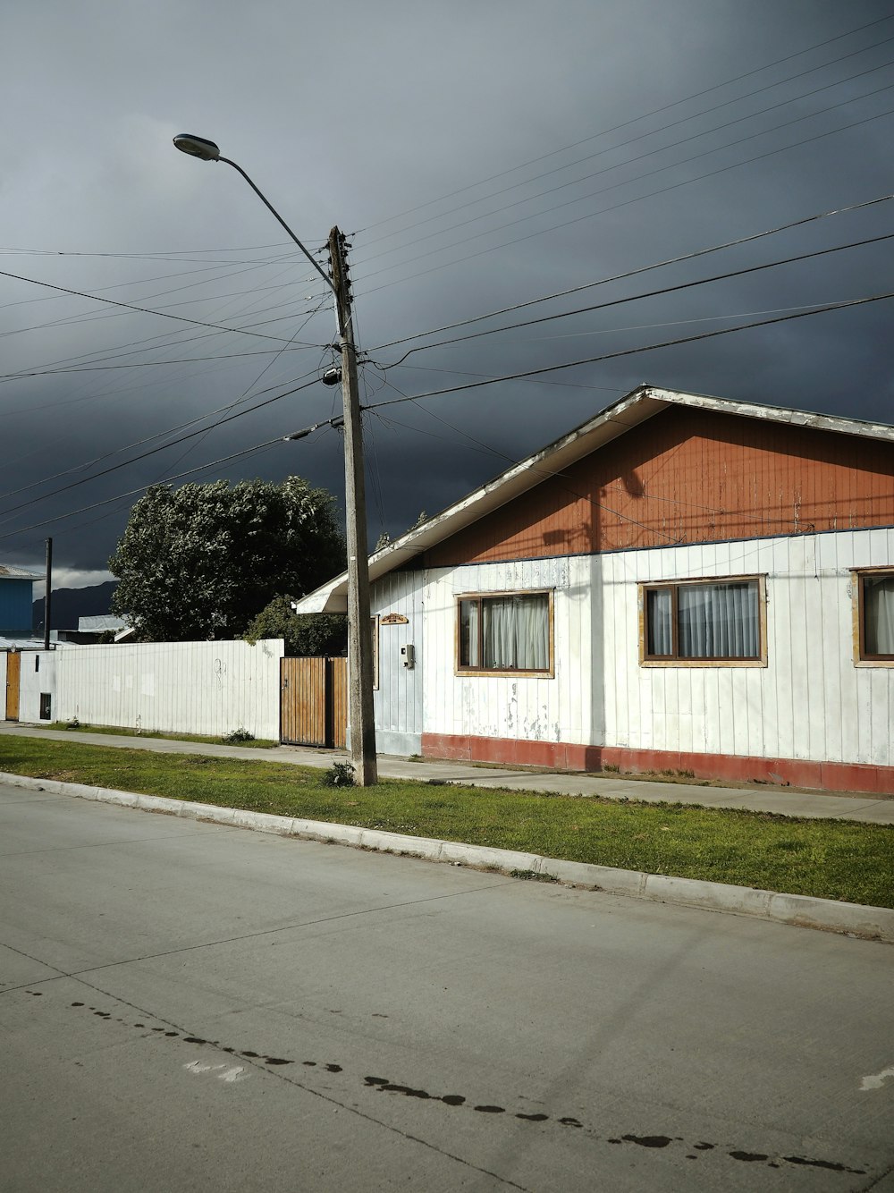 white and brown wooden house near gray electric post