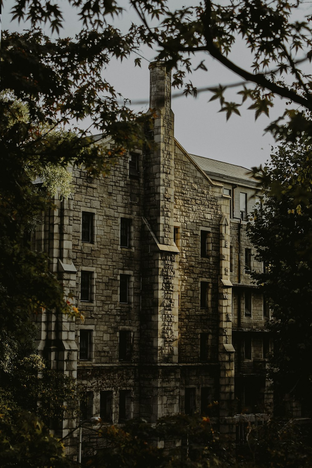 brown brick building near green trees during daytime