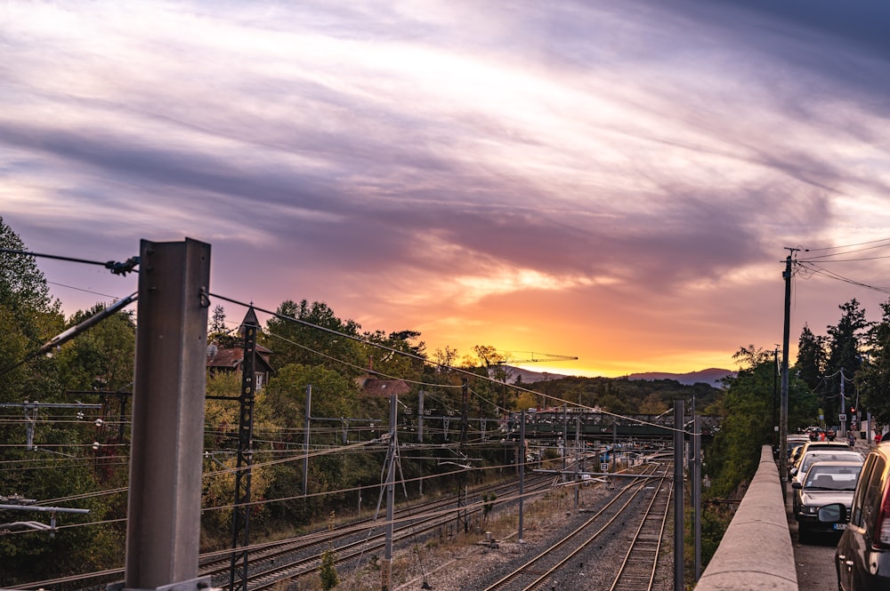 train rail under cloudy sky during sunset