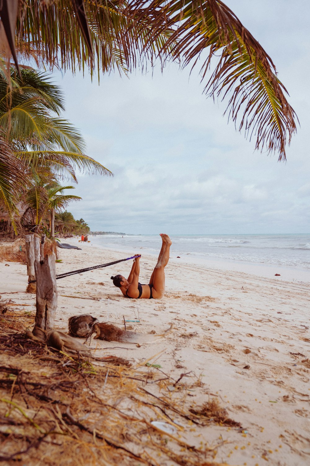 woman in brown dress sitting on beach during daytime