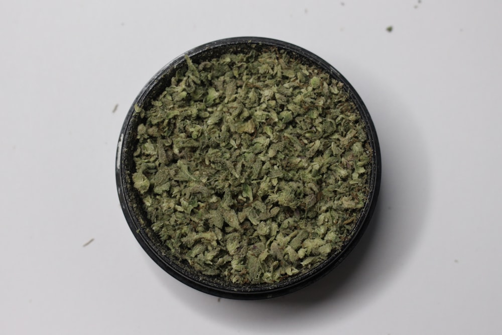 green kush in black round container