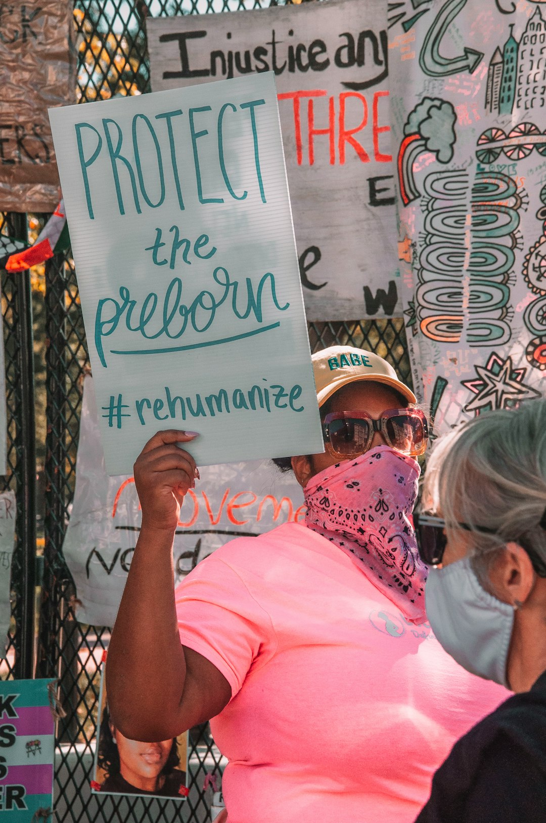 woman in pink shirt wearing white helmet