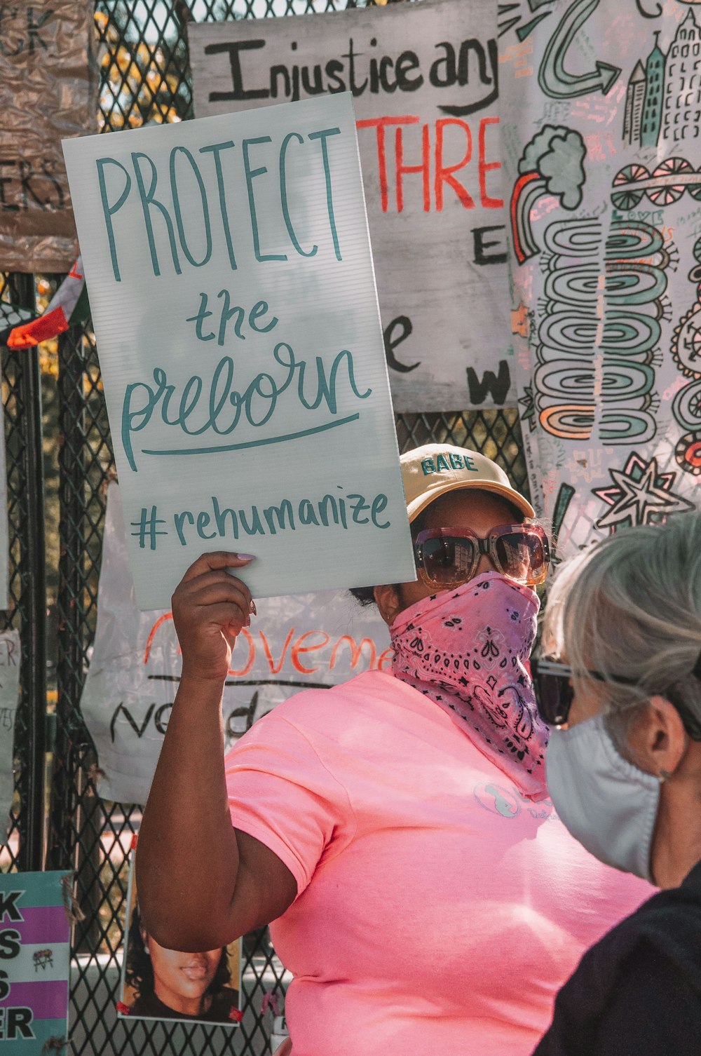 woman in pink shirt wearing white helmet