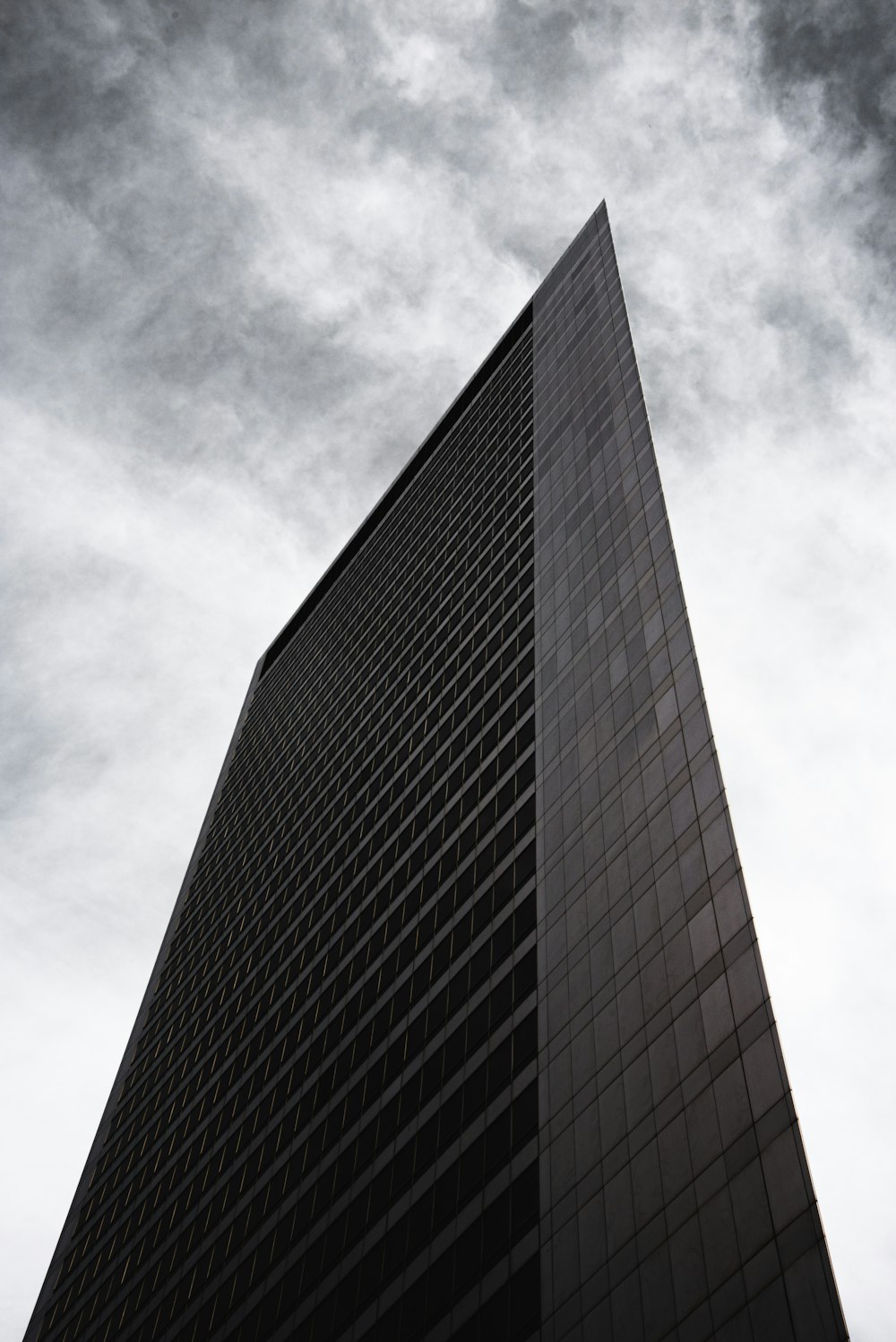 black and gray concrete building under white clouds