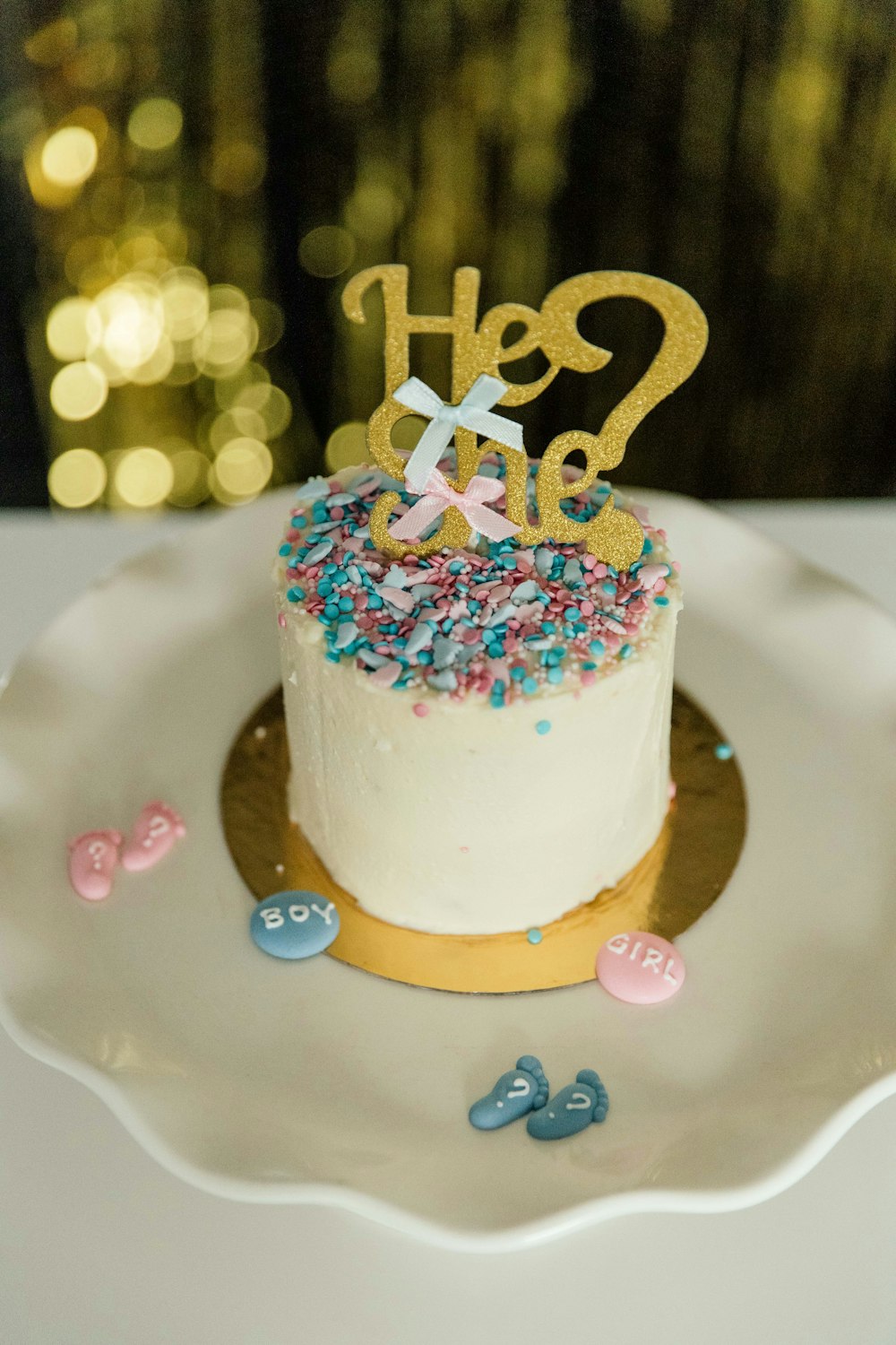 white and brown cake with pink heart shaped icing on white ceramic plate