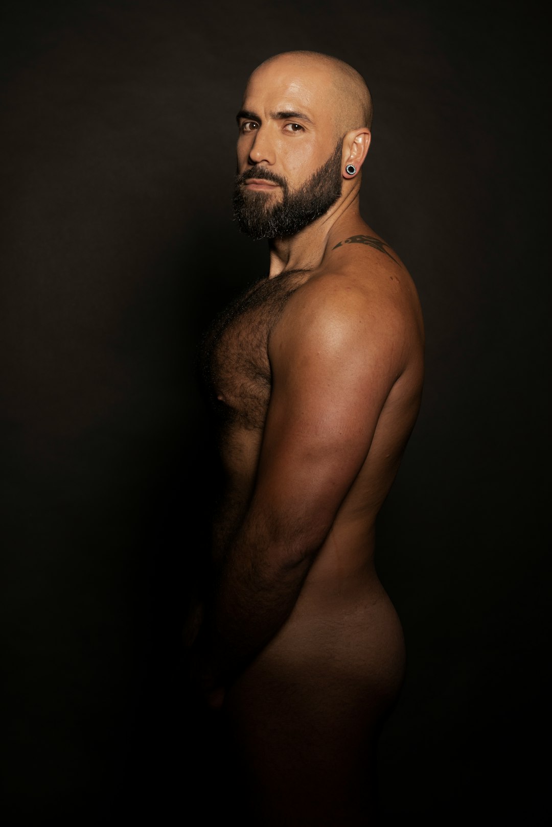 topless man with black background