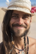 A peaceful person wearing a killercoil coil, smiling gently.