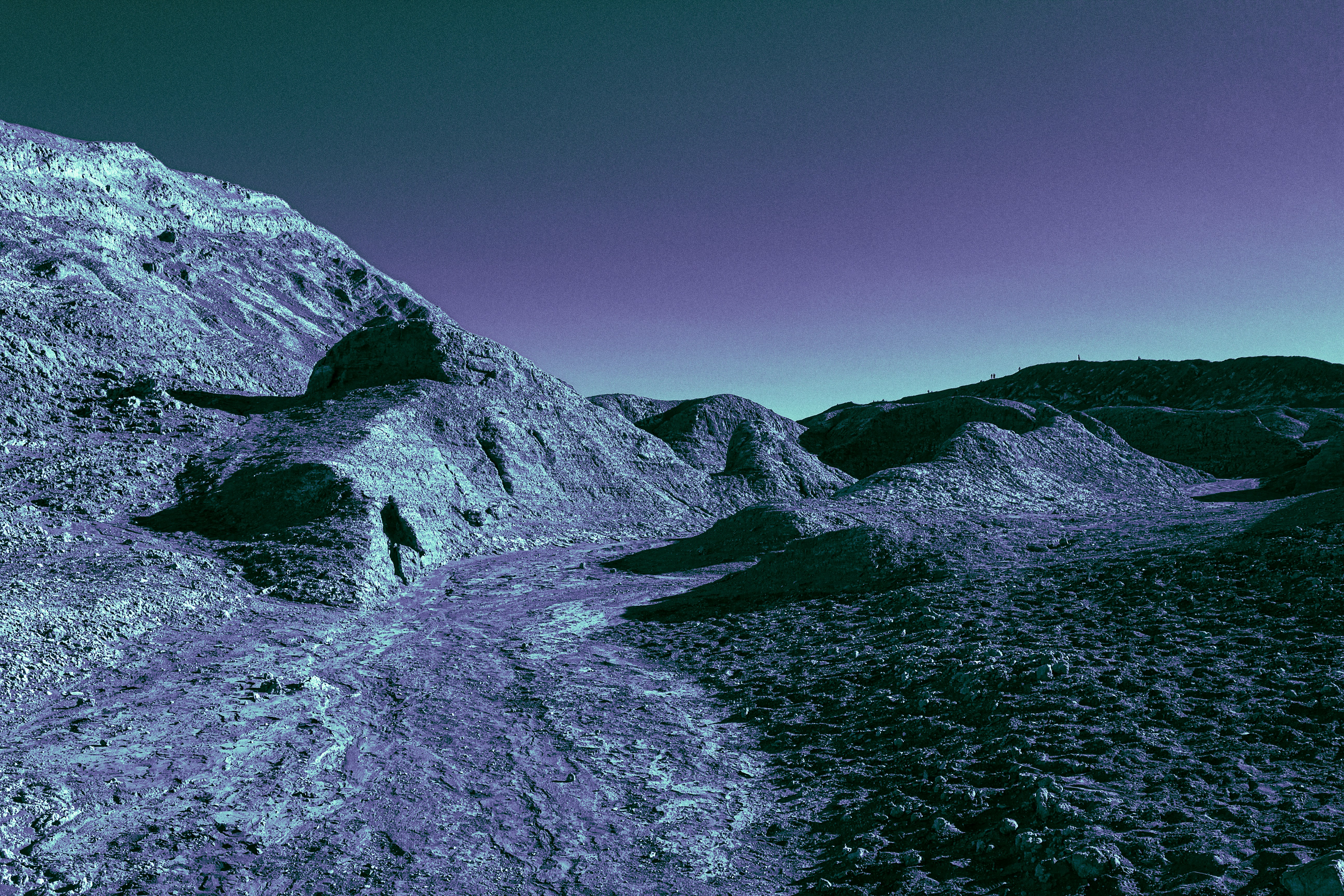 gray rocky mountain beside body of water during daytime
