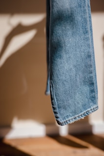 blue denim jeans on black plastic clothes hanger