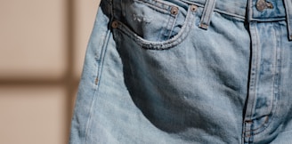 blue denim jeans on brown clothes hanger