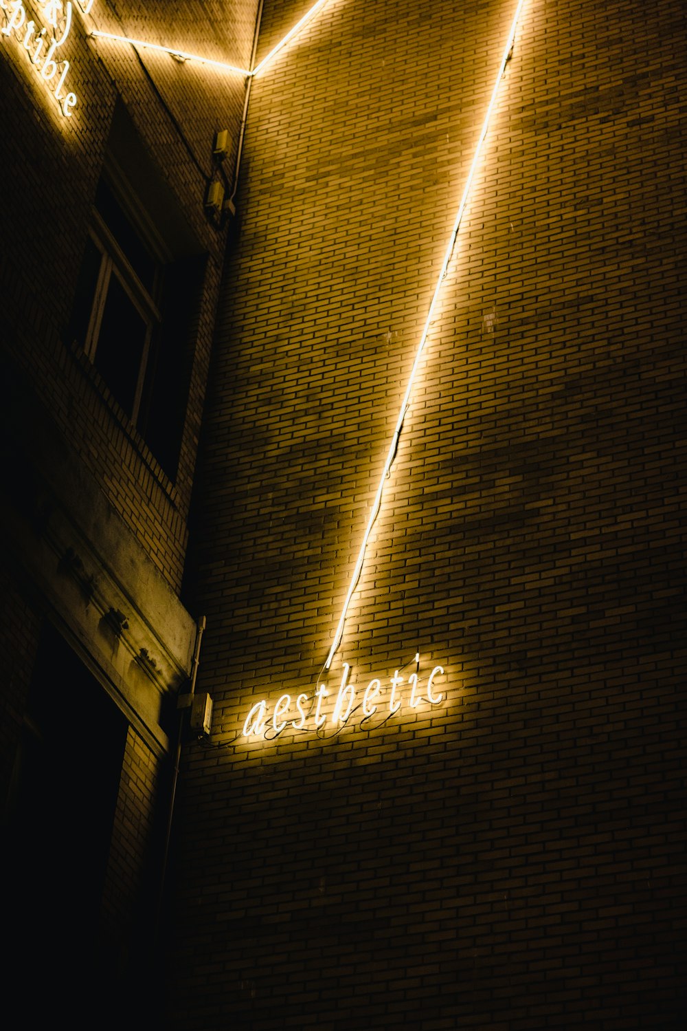 white string lights on brown concrete building during night time