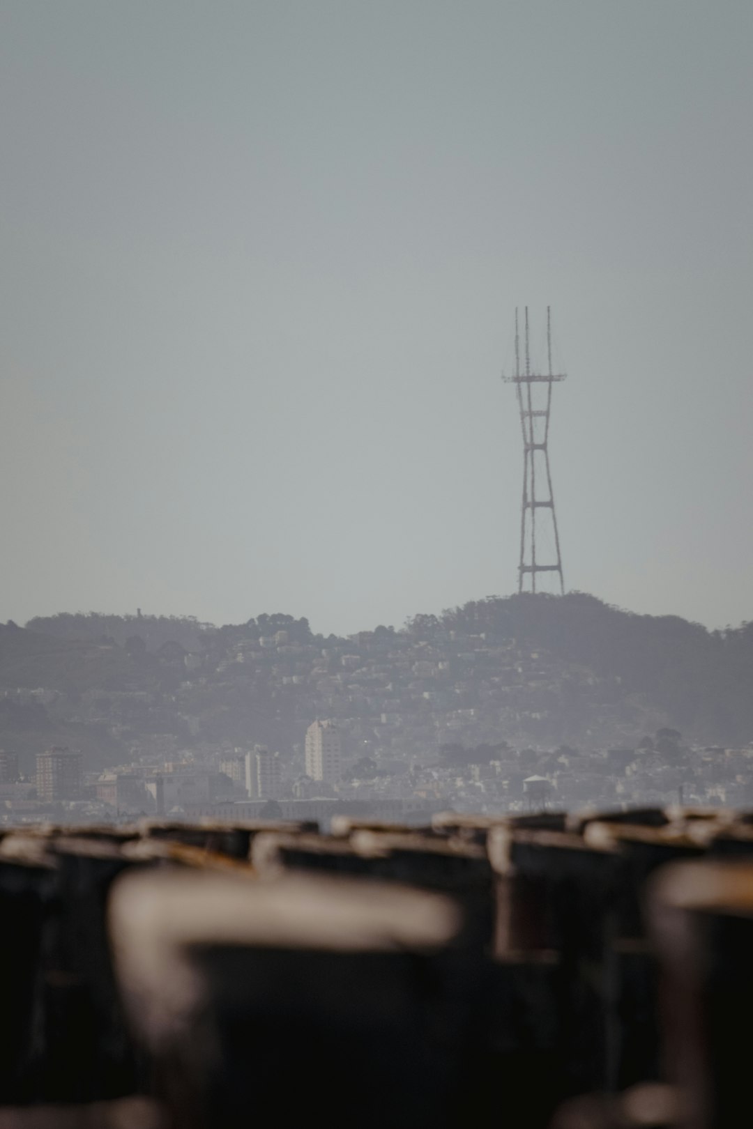 black metal tower near city buildings during daytime