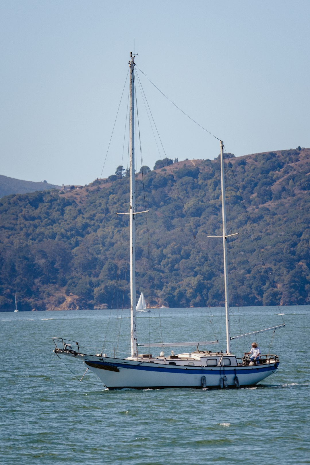 white and blue boat on sea during daytime