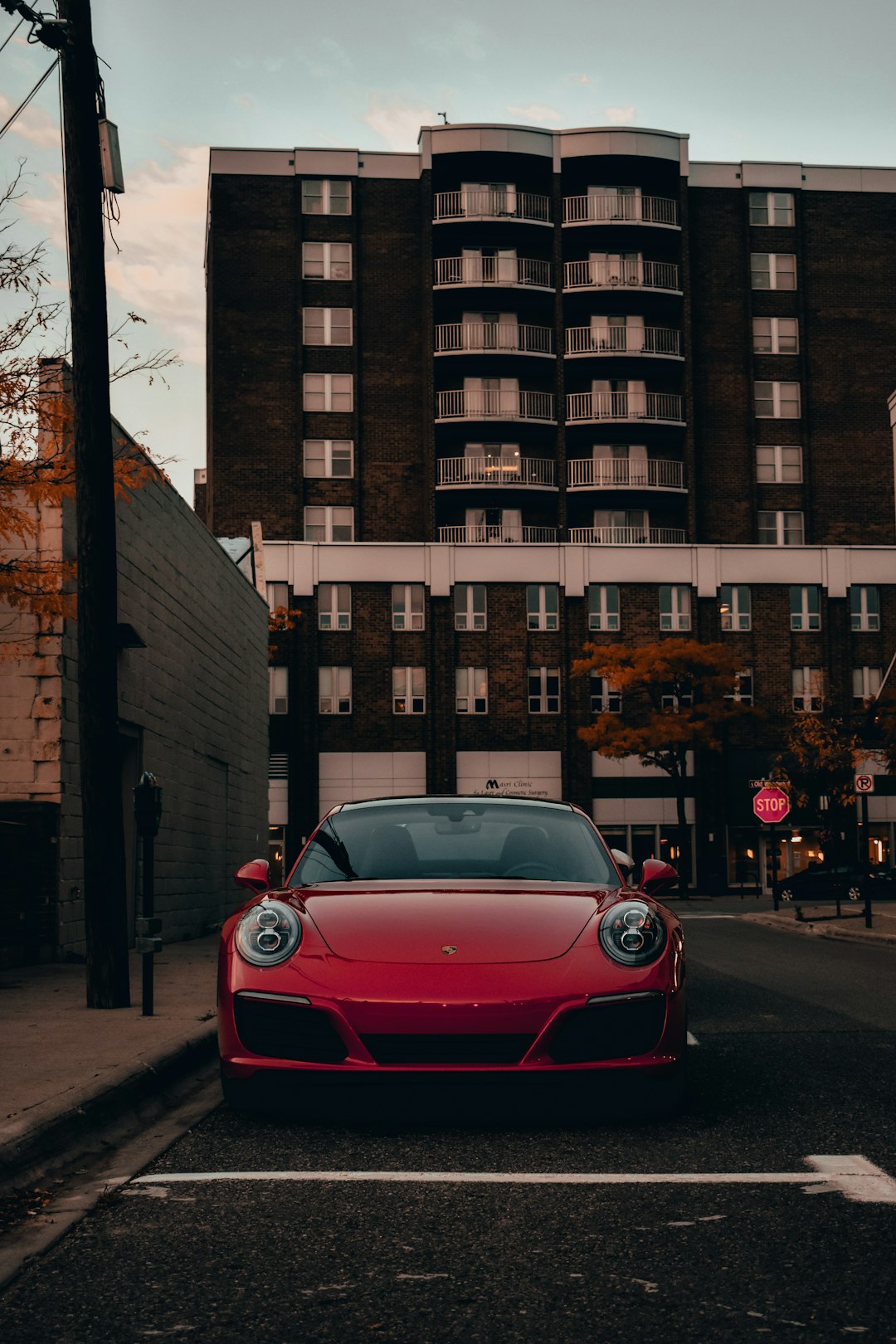 red ferrari car parked beside brown building during daytime