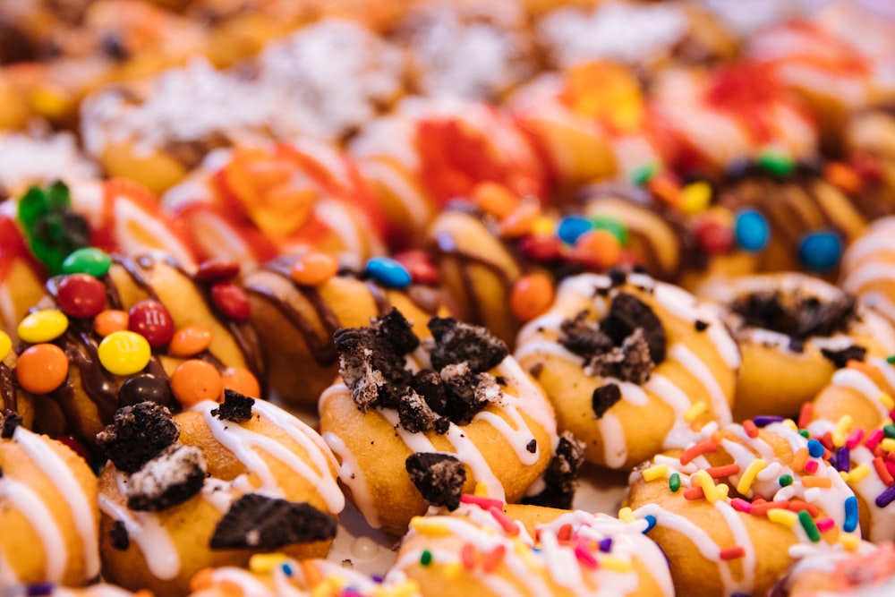 brown and black doughnut with white cream and sprinkles