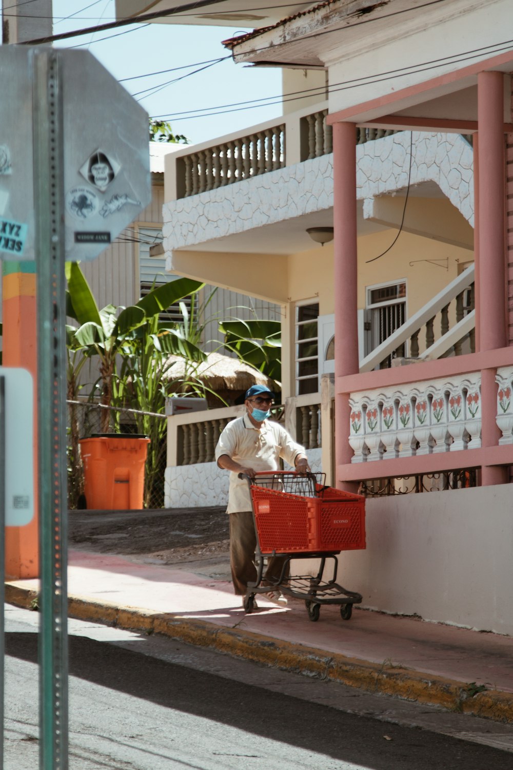 woman in white long sleeve shirt and red skirt sitting on red plastic crate