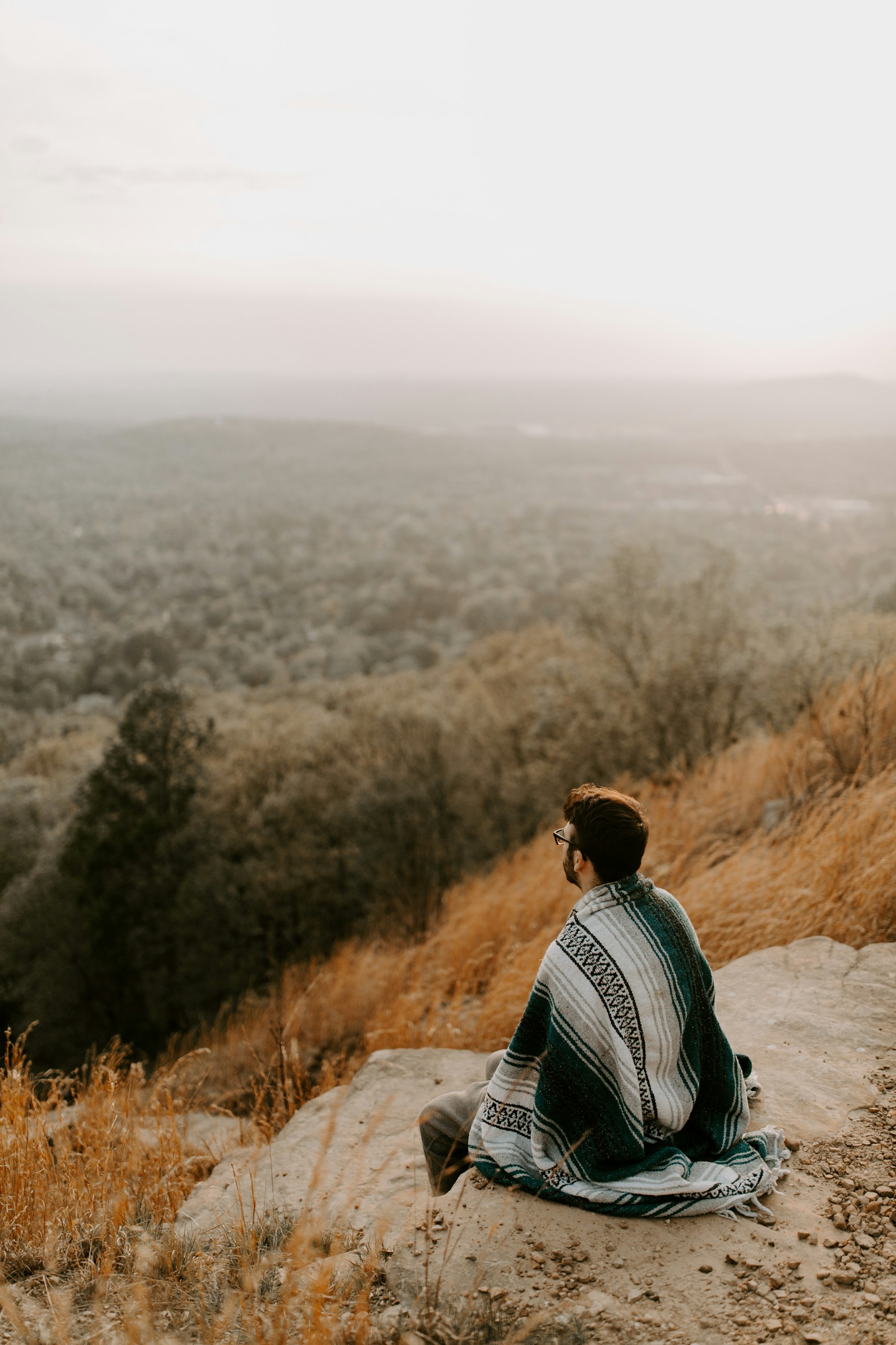 man sitting on the edge looking out